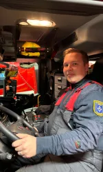 Juho in the driver's seat of a fire engine, wearing a volunteer fire brigade uniform.